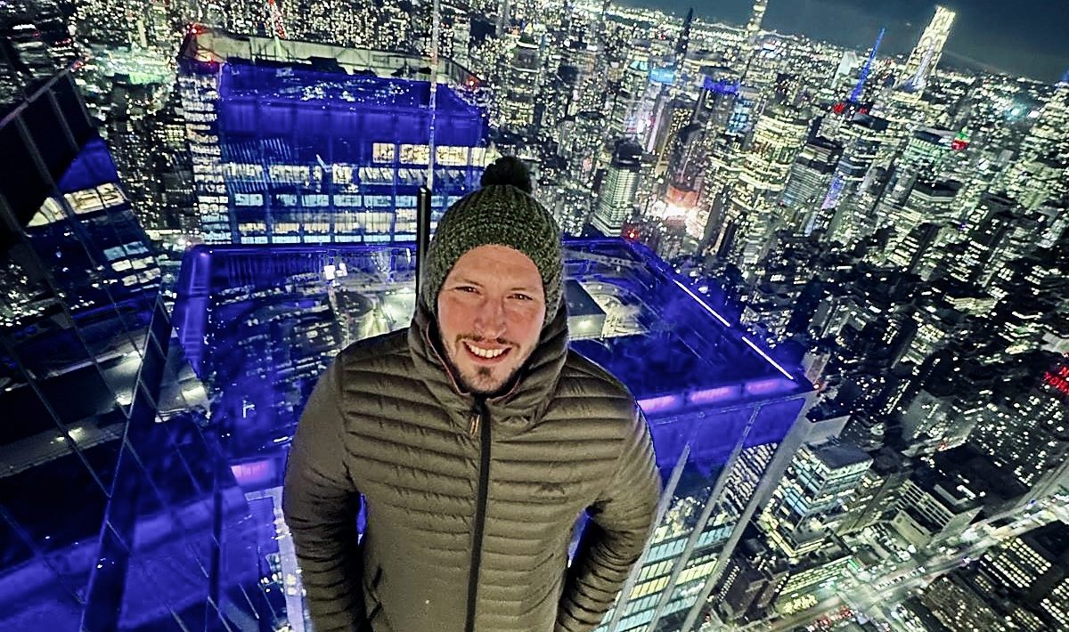 Ian Sharpe above the Manhattan skyline at night